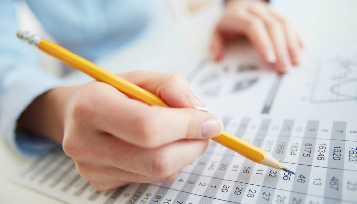 Close-up image of a financial worker analyzing statistical data